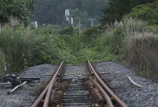 In this Friday, Sept. 4, 2015 photo, the rusty train track of Joban line is covered with weeds near the Tatsuta Station in Naraha town, Fukushima prefecture, northeastern Japan. This past weekend, Naraha became the first of seven towns that had been entirely evacuated to reopen since the March 11, 2011, disaster, when a tsunami slammed into the Fukushima Dai-ichi nuclear power plant, causing meltdowns and a massive radiation leak. The towns viability is far from certain, and its fate will be watched closely by authorities and neighboring towns to see if recovery is indeed possible in this radiation-contaminated land. (AP Photo/Koji Sasahara)