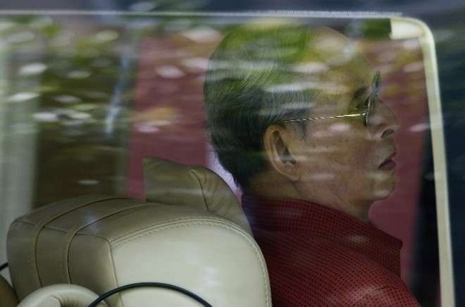 Thai King Bhumibol Adulyadej sits in his car as he leaves the Siriraj hospital in Bangkok on his way to his coastal palace in the southern city of Hua Hin on May 10, 2015. Thailand's revered but ailing king has been placed on antibiotics following a fresh blood infection, the palace revealed Monday, Sept. 7, amid public concern over the health of the world's longest-serving monarch.  AFP PHOTO/CHRISTOPHE ARCHAMBAULT