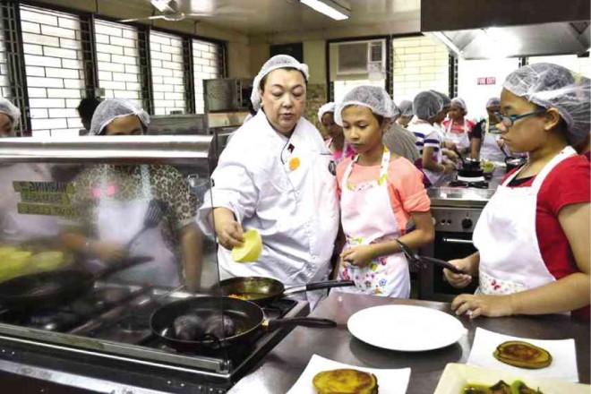 RICA Valdez gives participants last-minute instructions before they start cooking.