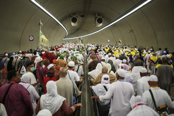 Muslim pilgrims walk in a tunnel on their way to cast stones at Jamarrat pillars, a ritual that symbolises the stoning of Satan, during the annual pilgrimage, known as the hajj, in Mina, near the holy city of Mecca, Saudi Arabia, Friday, Sept. 25, 2015. (AP Photo/Mosa'ab Elshamy)