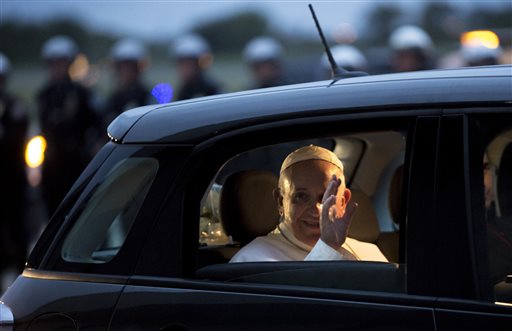 Pope Francis waves from his Fiat as he prepares to depart for Rome at Philadelphia International Airport in Philadelphia on Sunday, Sept. 27, 2015.  AP PHOTO/LAURENCE KESTERSON