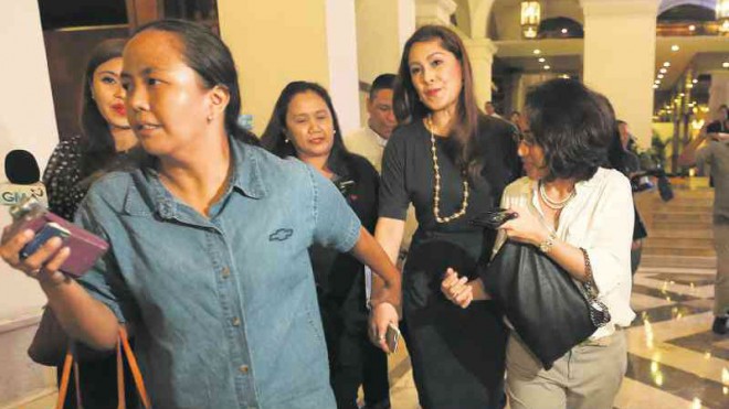 SCENE STEALER  An unidentified companion leads TV-movie star Sheryl Cruz  (in black, center) out of the Manila Hotel where she was scheduled to hold a tell-all interview on her cousin Sen. Grace Poe’s presidential run in 2016 and the DNA testing meant to establish the senator’s citizenship.  But Cruz, who intended to hold the interview during the grand press conference of the Iglesia ni Cristo biopic of its founder Felix Manalo, was disinvited by its organizers. They did not want the event to be dragged into politics, the movie producers said.  LYN RILLON