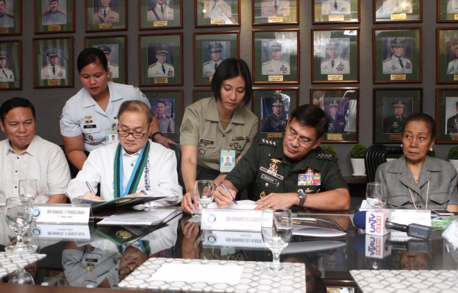 Former Armed Forces chief  Usec Emmanuel Bautista (extreme left) looks on as Makati Medical Center (MMC) Foundation Chairman Manuel V. Pangilinan (next to him) signs a memorandum of agreement with Armed Forces of the Philippines (AFP) Chief of Staff General Hernando DCA Iriberri which seeks to strengthen the partnership between the two (2) agencies for better military hospitals in the future. Judy A. Roxas, Director of Medical Doctors Inc. (also known as, Makati Medical Center) sits at the extreme left of the group. Gen. Iriberri and Pangilinan signed the MOA at Camp General Emilio Aguinaldo at 2 p.m. today. Photo by PO3 Jayson Rutao PN (PAO AFP)