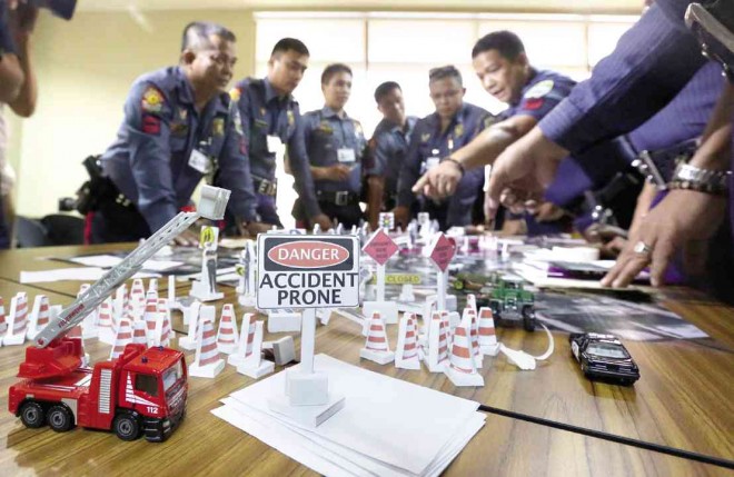 WITH the help of miniature vehicles and road signs, members of the Philippine National Police-Highway Patrol Group map out their game plan to restore order on Edsa starting today.  MARIANNE BERMUDEZ