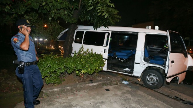 Policemen secure a bullet-riddled white Hyundai van along Katipunan Ave. Extension, Barangay White Plains. Witnesses along the area said the incident happened around 7 p.m. when men aboard a moving motorcycle shot at the van, hitting the driver, later taken away to a nearby hospital. INQUIRER PHOTO/LYN RILLON 