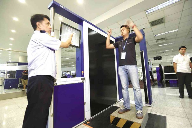 IDLE ASSETS   After  the initial demo as shown in this Aug. 11, 2015, file photo, the 14 full-body scanners costing P150 million have not been used at any of the four Naia terminals as many airport personnel have yet to learn how to operate the equipment.   Edwin Bacasmas