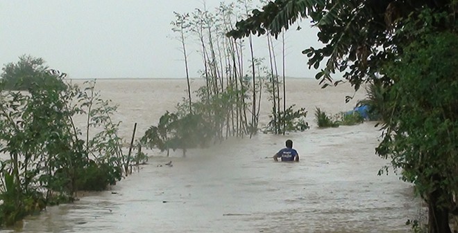 TYPHOON LANDO / OCTOBER 18, 2015 Unmindful of the risk, a man wades through a flooded road--with the submerged cornfield on its side--as 4,000-cubic-meter-per-second Magat dam water releases caused massive flooding in Isabela on Sunday. (VILLAMOR VISAYA JR./INQUIRER NORTHERN LUZON)