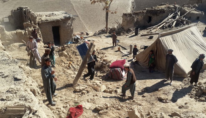 Afghan men carry their belongings after an earthquake in Takhar province, northeast of Kabul, Afghanistan, Tuesday, Oct. 27, 2015. Rescuers were struggling to reach quake-stricken regions in Pakistan and Afghanistan on Tuesday as officials said the combined death toll from the previous day's earthquake rose to more than 300. (AP Photo/Zalmai Ashna)