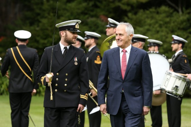 Australian Prime Minister Malcolm Turnbull (front R) inspects the New Zealand Navy guard of honour at Government House in Auckland on 17 October 2015. Turnbull is in New Zealand to conduct bilateral talks with John Key on his first overseas trip as Australian prime minister. AFP Photo / Fiona Goodall