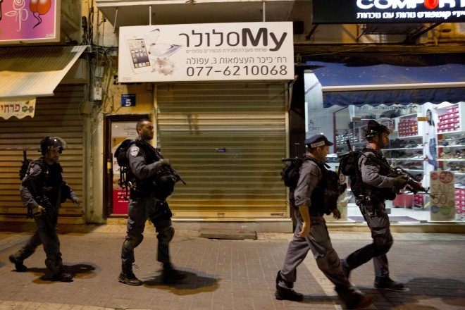 Israeli police officers patrol near the site of a stabbing attack in Afula, northern Israel, Thursday, Oct. 8, 2015. After attacks in Jerusalem and the West Bank left two Israelis seriously wounded Thursday, the violence spread deeper into Israel when police said an Arab attacker stabbed and moderately wounded an Israeli soldier in Afula. (AP Photo/Ariel Schalit)