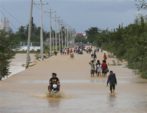 Residents wade through floodwaters brought about by Typhoon Koppu at Zaragosa township, Nueva Ecija provinc,e north of Manila, Philippines Monday, Oct. 19, 2015.  AP