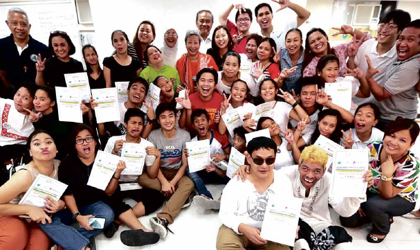 ARTSANDTECH FOR CLIMATE CHANGE Recent graduates of the first ever Unesco Techno Arts Camp for Climate Change show off their certificates after a performance showcasing their talents at the Boy Scouts of the Philippines building inManila. The camp taught the participants, some of them persons with disabilities and out-of-school youth, the importance of technology and arts in combating climate change. GRIG C. MONTEGRANDE