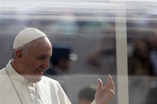 Pope Francis delivers a blessing as he arrives in St. Peter's Square for the weekly general audience, at the Vatican, Wednesday, Oct. 14, 2015. (AP Photo/Gregorio Borgia)