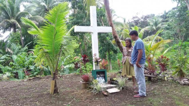 RODEL Barace of Antequera, Bohol province, visits the site where four members of his family died when the ground cracked and swallowed them two years ago. PHOTOS BY LEO UDTOHAN