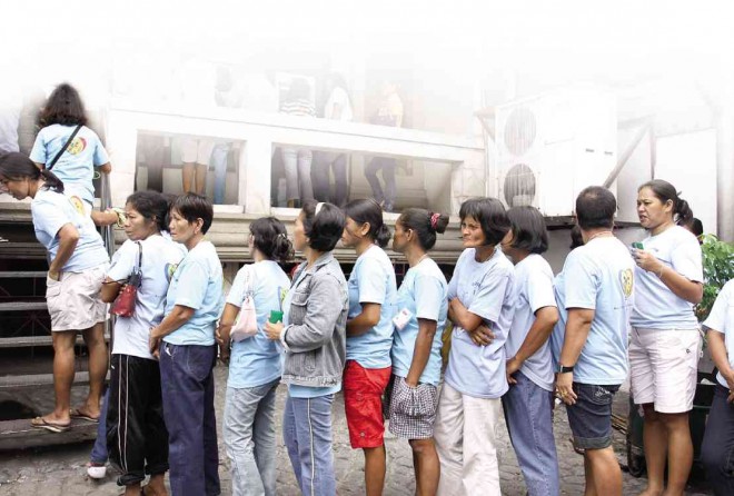 ONE OF THE WAYS the government distributes its cash stipend to the poor is through ATM, which explains the queue at an ATM booth in Lucena City in 2011. DELFIN MALLARI/INQUIRER SOUTHERN LUZON