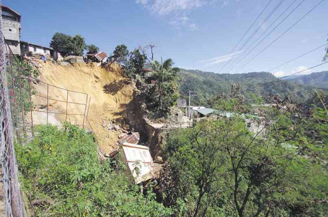 A HOLE that opened up in Barangay Virac in Benguet’s mining town of Itogon, swallowed six houses since Oct. 22. Richard Balonglong/INQUIRER NORTHERN LUZON