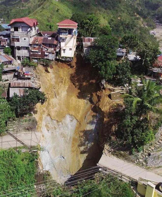 A HOLE gave way near three houses in Virac village in Benguet’s mining town of Itogon on Thursday. Forty families were immediately evacuated to Virac Elementary School. ELIZA CONSUL/CONTRIBUTOR