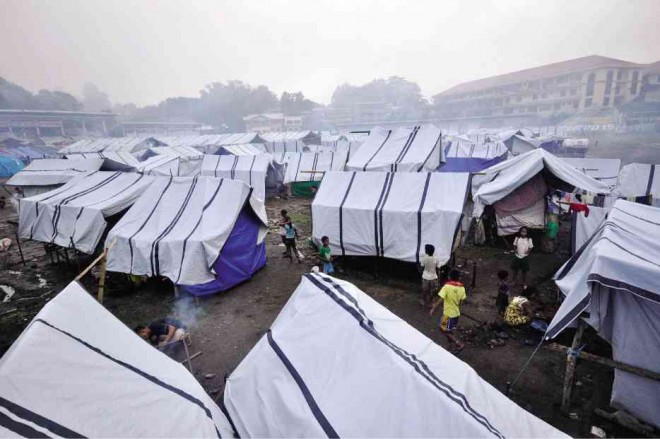 A tent city for close to 3,000 members of indigenous communities in Surigao del Sur province rises at a sports center in Tandag City after the indigenous peoples fled their homes following the killings of three “lumad” leaders on Sept. 1.  KING RODRIGUEZ/CONTRIBUTOR