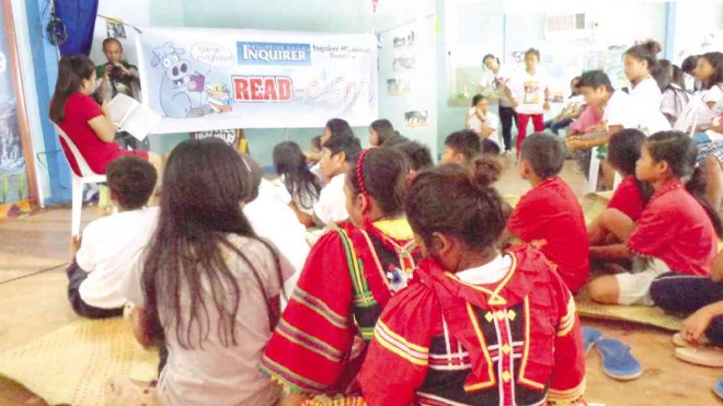 “LUMAD” children listen as Rosalinda Pimentel, wife of Surigao del Sur Gov. Johnny Pimentel, reads a story during Inquirer’s Read-Along session in Cortes, Surigao del Sur province, on Oct. 7. FRINSTON L. LIM