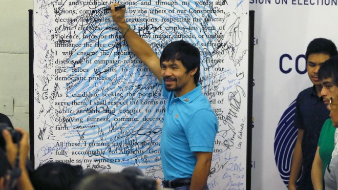 Filipino boxer Manny Pacquiao poses for the media after signing the "Integrity Pledge" following his filing the certificate of candidacy as a senatorial candidate in next year's presidential elections Friday, Oct. 16, 2015 in Manila, Philippines. More than 70 presidential hopefuls have filed their certificates of candidacy with Sen. Grace Poe and former Interior Secretary Mar Roxas considered as top contenders. Pacquiao is one of the most popular senatorial candidates. (AP Photo/Bullit Marquez)