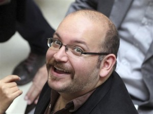 FILE - In this photo April 11, 2013 file photo, Jason Rezaian, an Iranian-American correspondent for the Washington Post, smiles as he attends a presidential campaign of President Hassan Rouhani in Tehran, Iran. Iran's official IRNA news agency reported that the verdict against Rezaian has been issued. Rezaian, the Post's Tehran bureau chief, is accused of charges including espionage in a closed-door trial that has been widely criticized by the U.S. government and press freedom organizations. (AP Photo/Vahid Salemi, File)