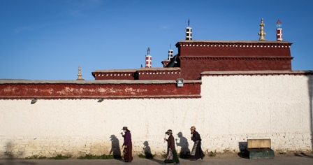 Tibetan pilgrims circumambulate a monastery in Nagqu.