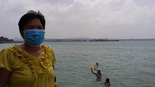 A woman in Bohol wears a face mask as protection from the haze.  Photo by Leo Udtohan, Inquirer Visayas
