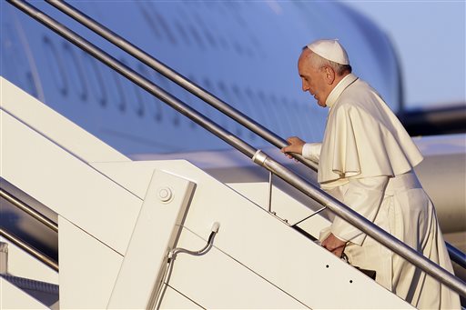 Pope Francis boards his airplane on the occasion of his trip to Africa, at Rome's Fiumicino International Airport, Wednesday, Nov. 25, 2015. Pope Francis is leaving for a trip that will take him to Kenya, Uganda and the Central African Republic, from Nov. 25-30. (AP Photo/Gregorio Borgia)