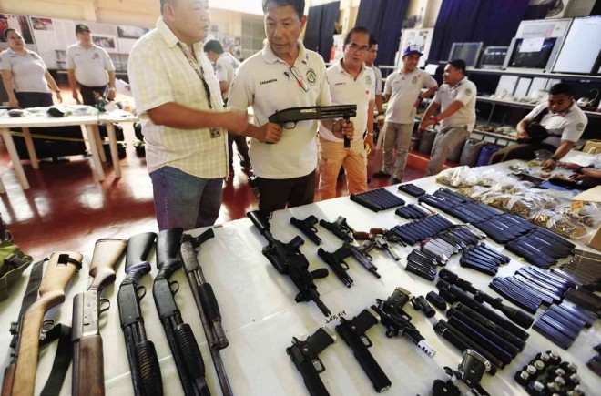 INMATES’ ARMORY Assorted firearms and ammunition are among the items authorities seized in dormitories where members of prison gangs stay at New Bilibid Prison in Muntinlupa City. Also confiscated were electronic gadgets and even a “musang” (civet cat) in a cage. EDWIN BACASMAS
