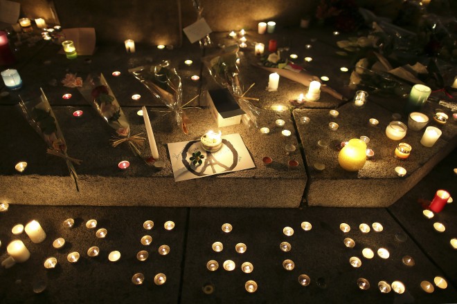 Candles read "peace" at a temporary memorial for the victims of the Paris attacks in Rennes, western France, Saturday, Nov. 14, 2015. French President Francois Hollande vowed to attack the Islamic State group without mercy as the jihadist group claimed responsibility Saturday for orchestrating the deadliest attacks on France since World War II. (AP Photo/David Vincent)
