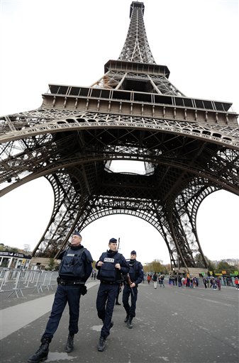 Police officers patrol at the Eiffel Tower in Paris, Tuesday, Nov. 17, 2015. The Eiffel Tower has closed again, one day after it reopened following the Paris attacks. The landmark reopened to visitors Monday after being shut for two days after the Paris gun and bomb attacks that killed more than 120 people. (AP Photo/Frank Augstein)