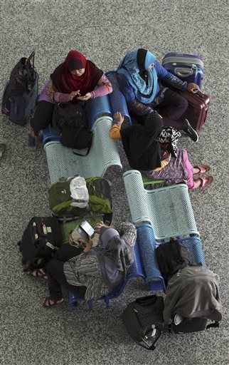 Passengers wait as their flights are canceled  at Ngurah Rai International Airport in Bali, Indonesia on Wednesday, Nov. 4, 2015. Ash spewing from a rumbling volcano in eastern Indonesia blanketing villages with thick ash, forcing the closure of two airports and international airlines canceled flights to tourist hotspot Bali, stranding thousands. (AP Photo/Firdia Lisnawati)