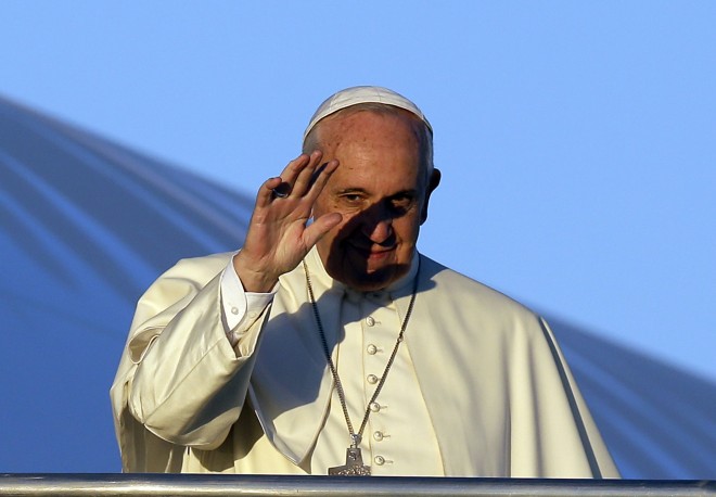 Pope Francis waves to journalists as he boards his airplane on the occasion of his trip to Africa, at Rome's Fiumicino International Airport, Wednesday, Nov. 25, 2015. Pope Francis is leaving for a trip that will take him to Kenya, Uganda and the Central African Republic, from Nov. 25-30. (AP Photo/Gregorio Borgia)