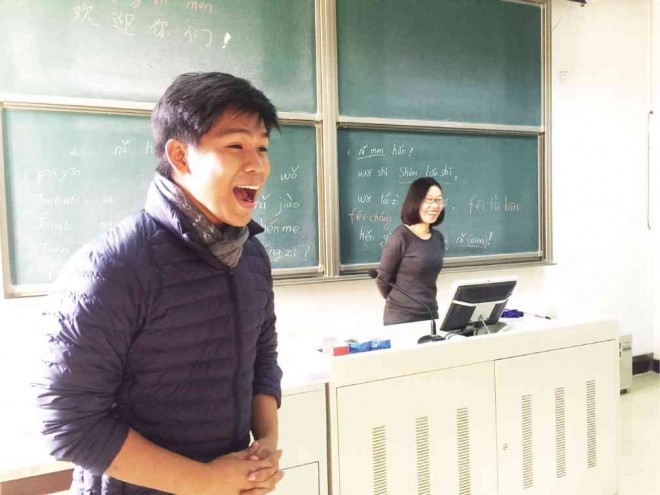 Magtalas tries a Chinese phrase as language teacher Shan Xiubo listens.