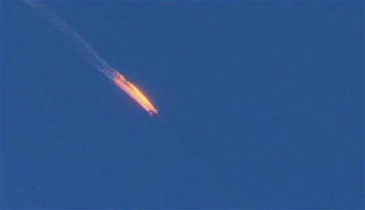This frame grab from video by Haberturk TV, shows a Russian warplane on fire before crashing on a hill as seen from Hatay province, Turkey, Tuesday, Nov. 24, 2015. Turkey shot down the Russian warplane Tuesday, claiming it had violated Turkish airspace and ignored repeated warnings. Russia denied that the plane crossed the Syrian border into Turkish skies. (Haberturk TV via AP)  TURKEY OUT