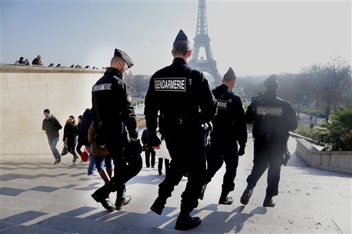 In this Monday, Nov. 23, 2015 file photo, French gendarmes officers patrol near the Eiffel Tower, in Paris. In the aftermath of the horrifying attacks in Paris on Nov. 13, 2015, people were so jittery that some loud, unremarkable noises were enough to send some people scurrying for help. Some experts say it will take months for Europeans to adapt to life after the paris attacks. AP