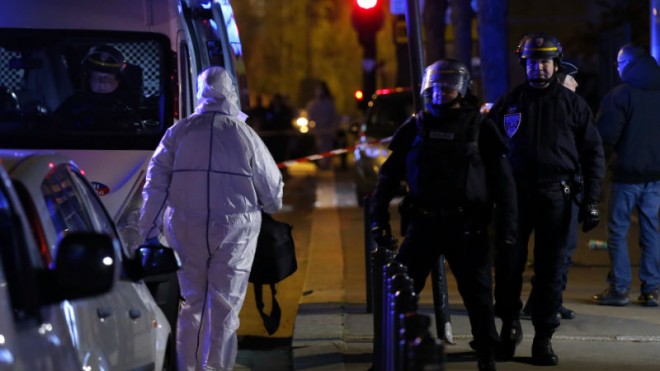 An investigating police officer, left, arrives outside the Stade de France stadium after an international friendly soccer match France against Germany, in Saint Denis, outside Paris, Friday Nov. 13, 2015. Several dozen people were killed in attacks around Paris on Friday, French President Francois Hollande said, announcing that he was closing the country’s borders and declaring a state of emergency. (AP Photo/Michel Euler)