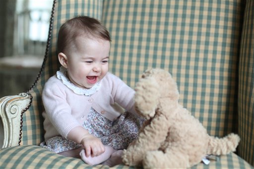 In this undated photo released Sunday Nov. 29, 2015, by Britain's Duke and Duchess of Cambridge, showing Princess Charlotte with her cuddly toy dog, at Anmer Hall in Sandringham, England.  Princess Charlotte was born May 2, 2015, and the photo was taken by her mother, Kate Duchess of Cambridge, during November 2015.  (Duchess of Cambridge via AP)