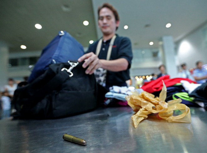 BULLET FOUND AT PASSENGER'S BAGGAGE AT NAIA TERMINAL 3/NOV.4,2015 A bullet is found in the baggage of Rey Salado, a passenger bound for Cagayan de Oro City at the NAIA Terminal 3. Salado admitted that the bullet was his after receiving it from a friend. INQUIRER PHOTO/RAFFY LERMA