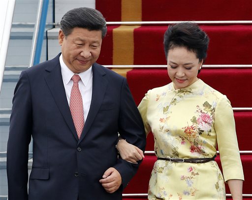 China's President Xi Jinping and his wife Peng Liyuan arrive at Noi Bai International Airport in Hanoi, Vietnam, Thursday, Nov. 5, 2015. Xi's visit to Vietnam on Thursday comes as the two communist countries seek to mend ties strained over territorial disputes in the South China Sea. (Luong Thai Linh/Pool Photo via AP)