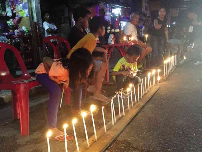 TWO YEARS AFTER STORM Children join the candlelighting event to commemorate the second anniversary of the Supertyphoon “Yolanda” tragedy in Tacloban City. PHILIPPINE INFORMATION AGENCY REGIONAL OFFICE/CONTRIBUTOR