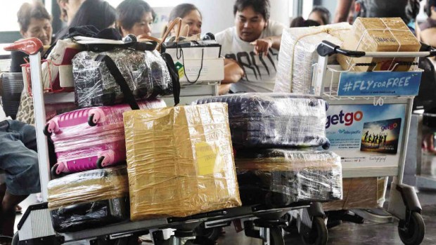 EXTRA PROTECTION   Passengers waiting for their flights at Ninoy Aquino International Airport (Naia) Terminal 3 go to great lengths to protect their luggage by having these wrapped in plastic to prevent anyone from planting bullets (“tanim-bala”) in their baggage. GRIG C. MONTEGRANDE/INQUIRER FILE PHOTO