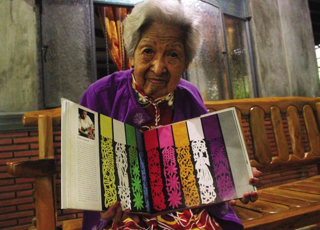 LUZ OCAMPO, 93, shows off some of her favorite designs of “pastillas” wrappers, all of which are patented in her name. RON LOPEZ/INQUIRER CENTRAL LUZON