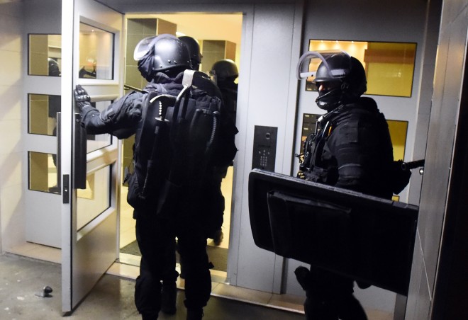 Anti terrorism police officers enter a building during a raid in the Mirail district in Toulouse, southwestern France, Monday, Nov. 16, 2015. France's Prime Minister Manuel Valls says there have been 150 police raids overnight in the country. (AP Photo) FRANCE OUT