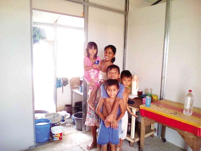 Jonalyn Medalla and her  children are happy  in their new home in the resettlement site for survivors of Supertyphoon “Yolanda” donated by Tzu Chi Foundation in Barangay Lilo-an, about 12 kilometers from the city proper of Ormoc in Leyte province. JOEY A. GABIETA