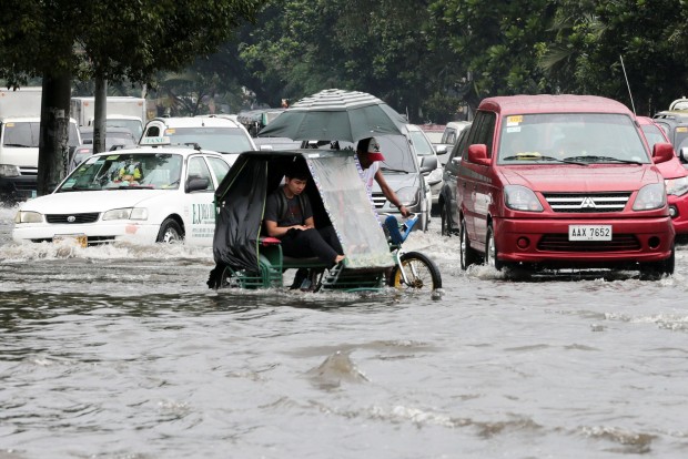 EASY TRANSPORT / DECEMBER 16, 2015 A pedicab negotiates a flooded street with other motorists in Manila on a stormy Wednesday afternoon, December 16, 2015. INQUIRER PHOTO / GRIG C. MONTEGRANDE