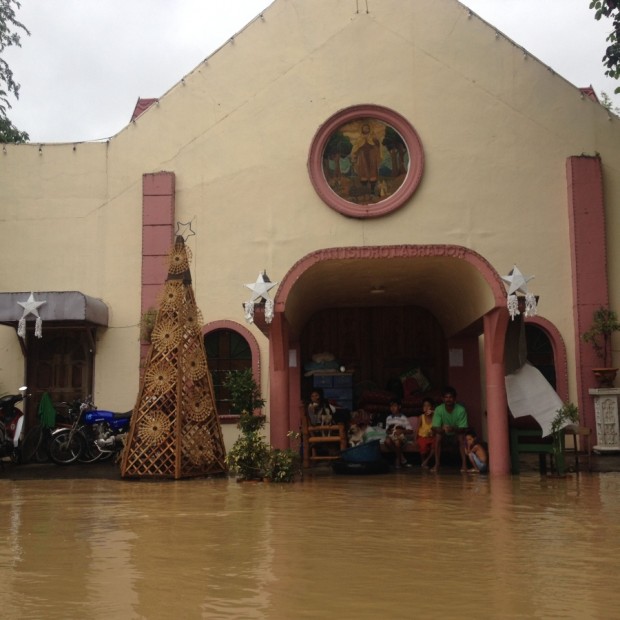 REFUGE FROM THE STORM The San Isidro Labrador Chapel took in two families from Barangay IbaO’Este in Calumpit town, Bulacan province, whose houses were flooded on Saturday due to the rains spawned by Typhoon “Nona.” The chapel had to suspend its 7 p.m.Mass to accommodate the evacuees. CARMELA REYES-ESTROPE
