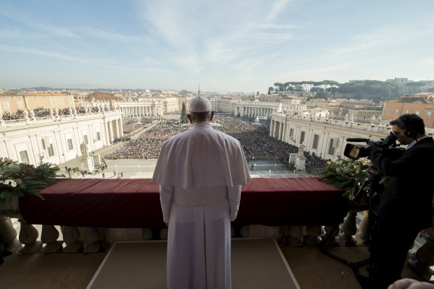 Pope Francis delivers his "Urbi et Orbi" (to the city and to the world) blessing from the central balcony of St. Peter's Basilica at the Vatican, Friday, Dec. 25, 2015. Pope Francis is praying that recent U.N.-backed peace agreements for Syria and Libya will quickly end the suffering of their people while praising the generosity of those countries that have taken their refugees in. AP