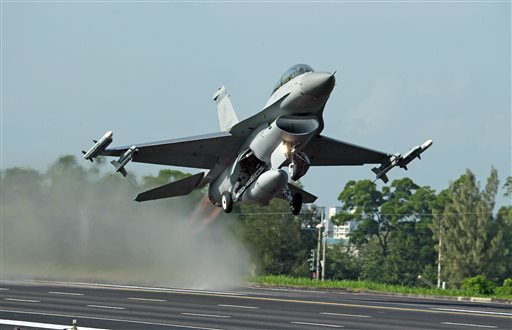 In this Sept. 16, 2014 file photo, a Taiwan Air Force F-16 fighter jet takes off from a closed section of highway during the annual Han Kuang military exercises in Chiayi, central Taiwan. China on Wednesday, Dec. 16, 2015 strongly criticized an expected U.S. arms sale to Taiwan, saying it should be canceled to avoid harming relations between Taipei and Beijing. (AP Photo/Wally Santana, File)