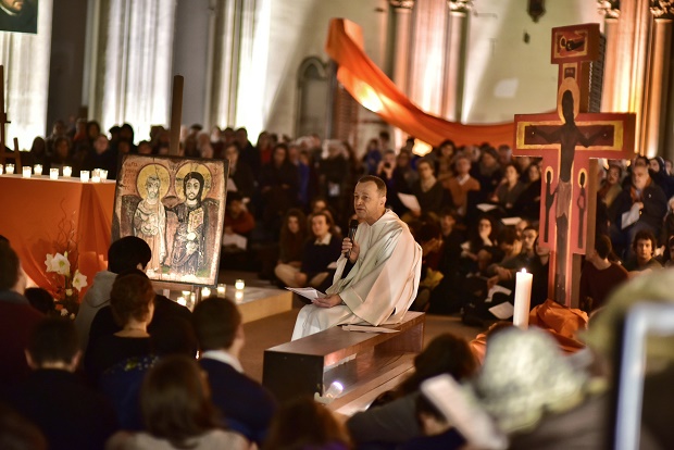In this photo dated Saturday, Dec 5, 2015, and provided by Taize, brother Alois, addresses people at an interfaith service for world leaders to curb global warming during a multi-lingual service at Church St Ignatius in Paris, France. The cold hard numbers of science haven't spurred the world to curb runaway global warming. So as climate negotiators struggle in Paris, some scientists who appealed to the rationale brain are enlisting what many would consider a higher power: the majesty of faith. (Marie Renaux/Taize via AP)